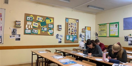 Powiększ grafikę: Zdjęcie uczniów w sali lekcyjnej piszących listy
